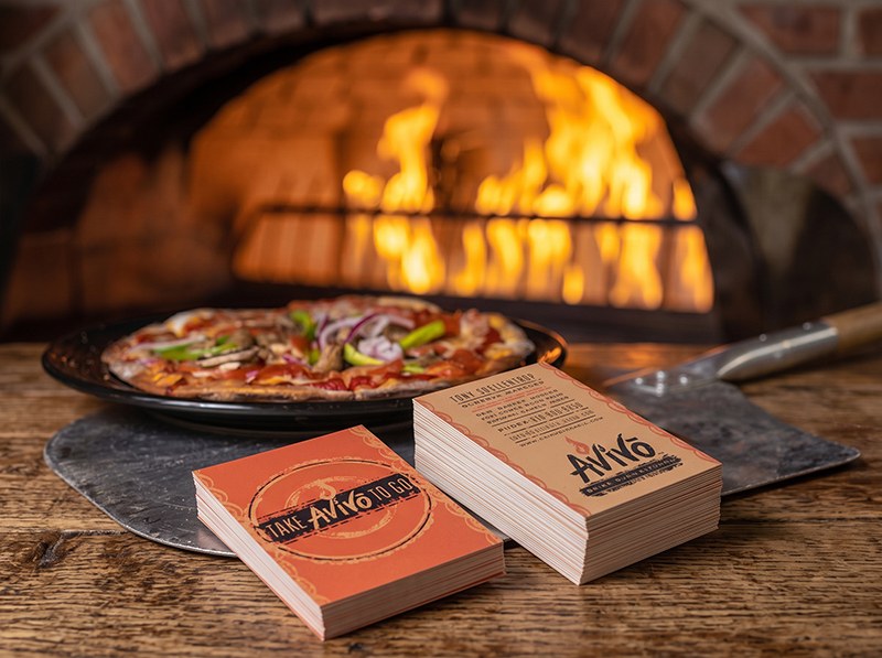 Avivo business cards on a peel by the brick oven fire